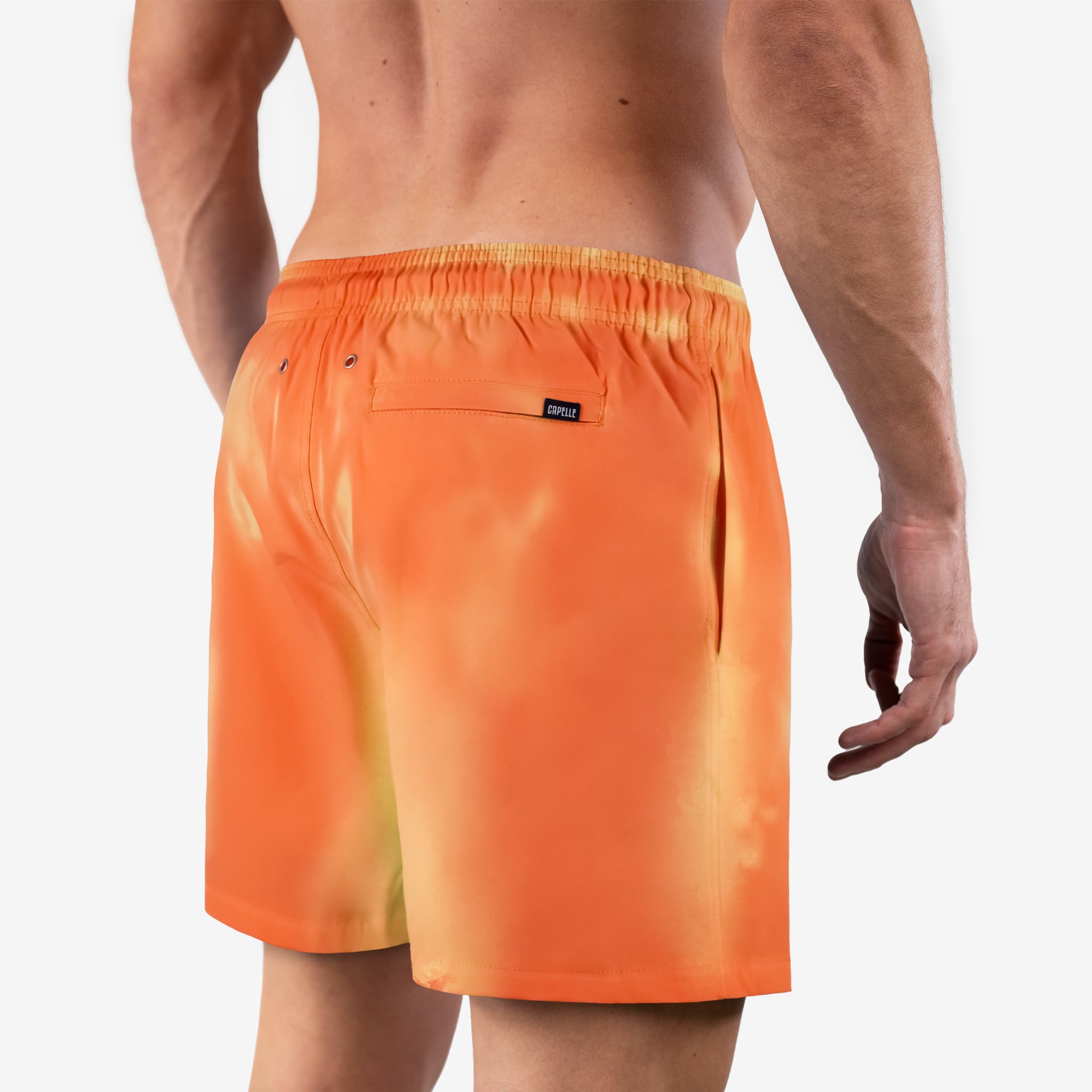 Orange swim shorts worn by a person on a white background