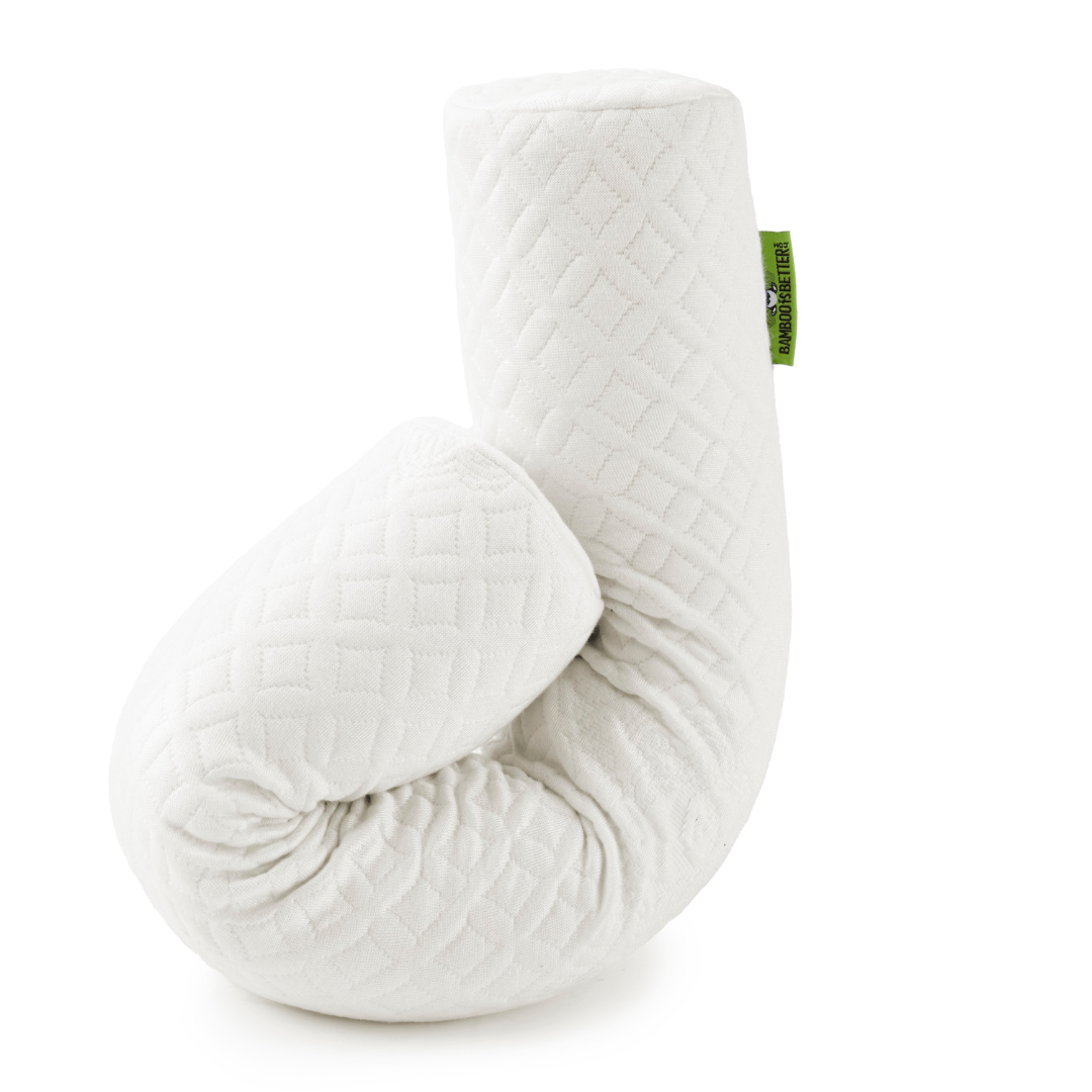 White quilted pillow with a green tag on a white background
