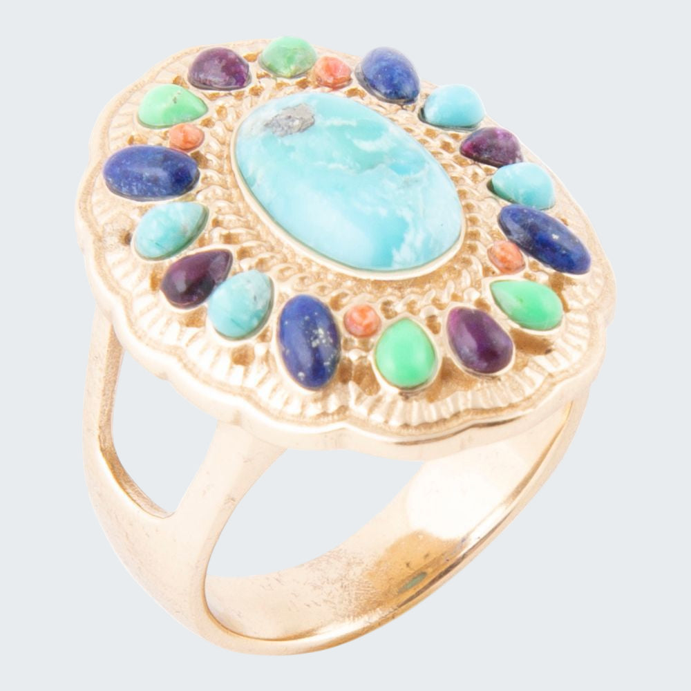 Gold ring with colorful gemstones on a white background