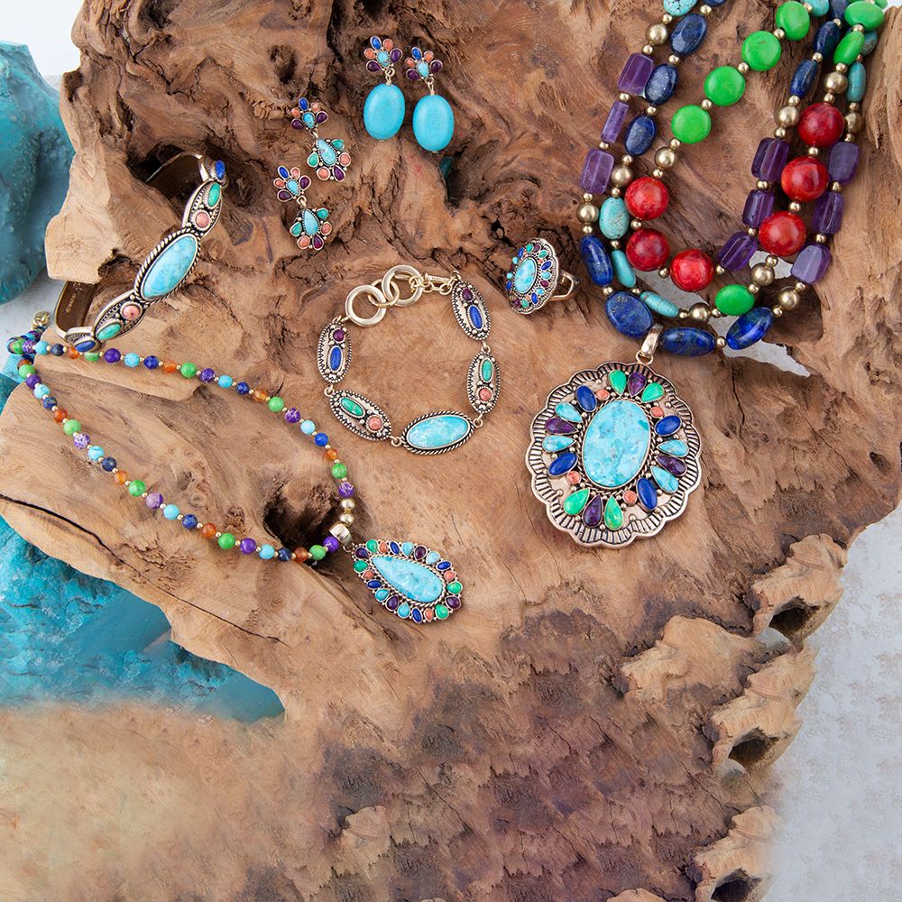 Colorful jewelry set including necklace, bracelet, and earrings on a wooden surface.