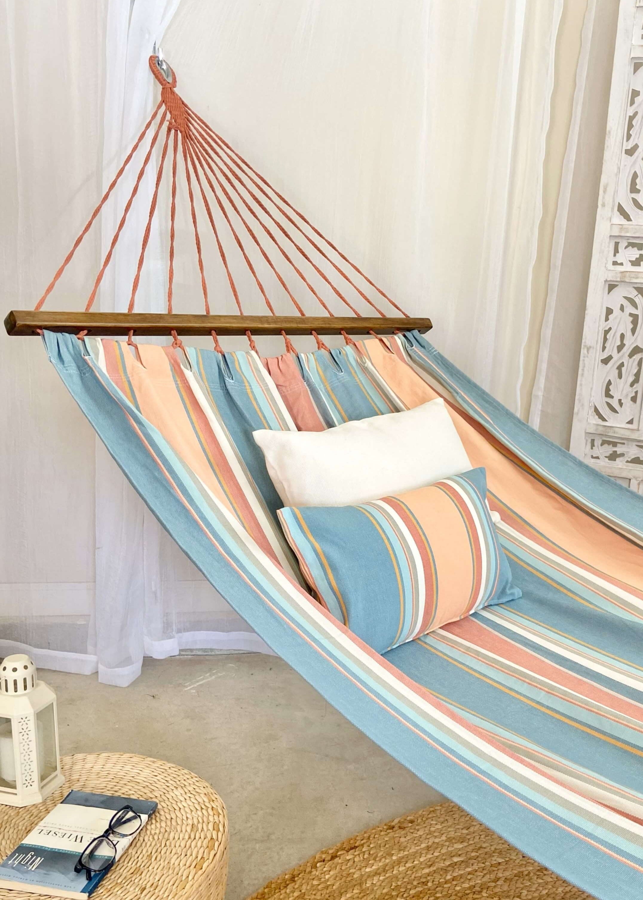 Striped hammock with pillows in a room setting