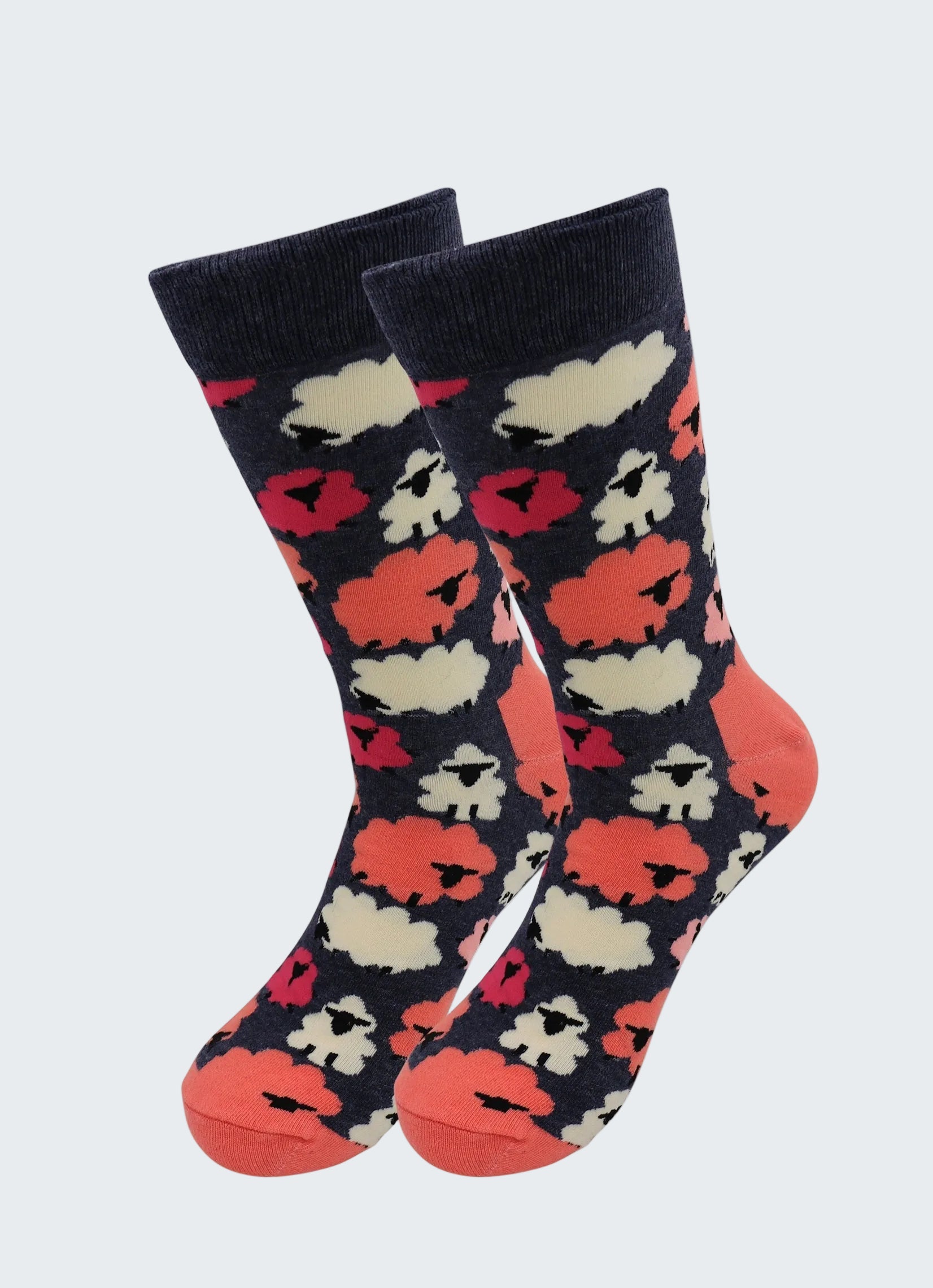 Pair of socks with a pattern of red, white, and black shapes on a dark background