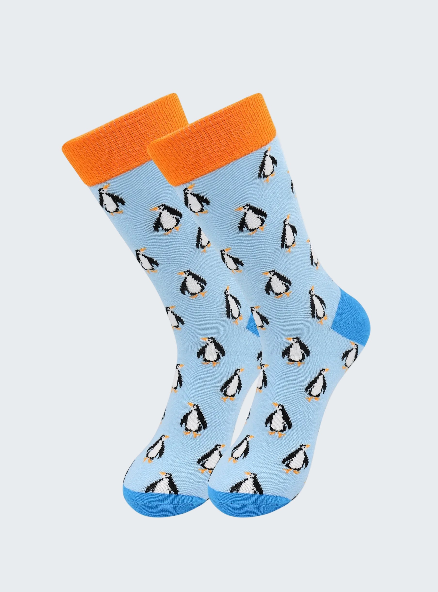 Light blue socks with penguin pattern and orange cuffs on a white background