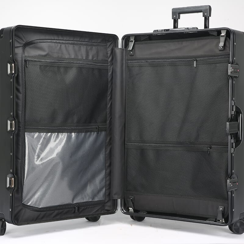 Black suitcase with open compartments on a white background