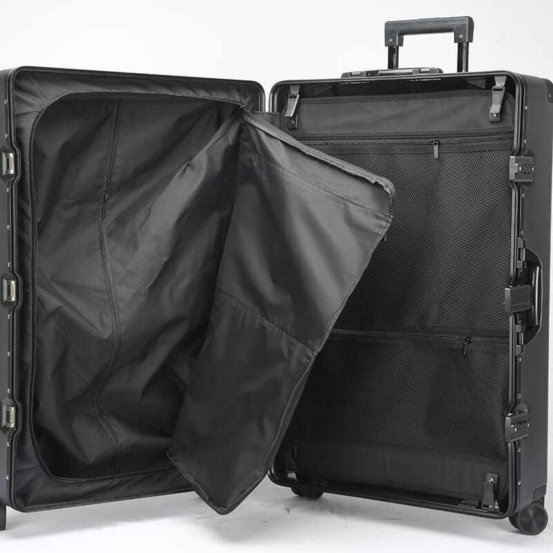 Black suitcase with open compartment on a white background
