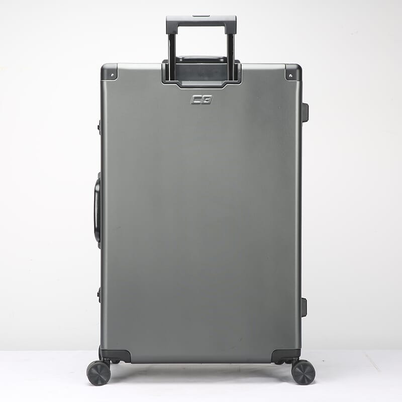 Silver suitcase with wheels and handle on a white background