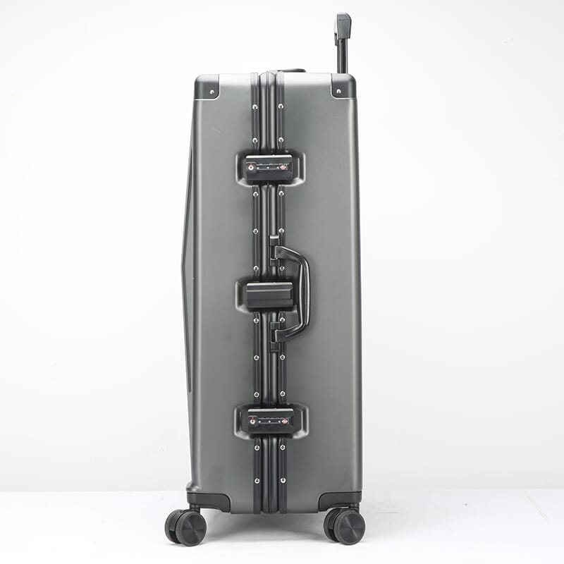 Silver suitcase with wheels on a white background
