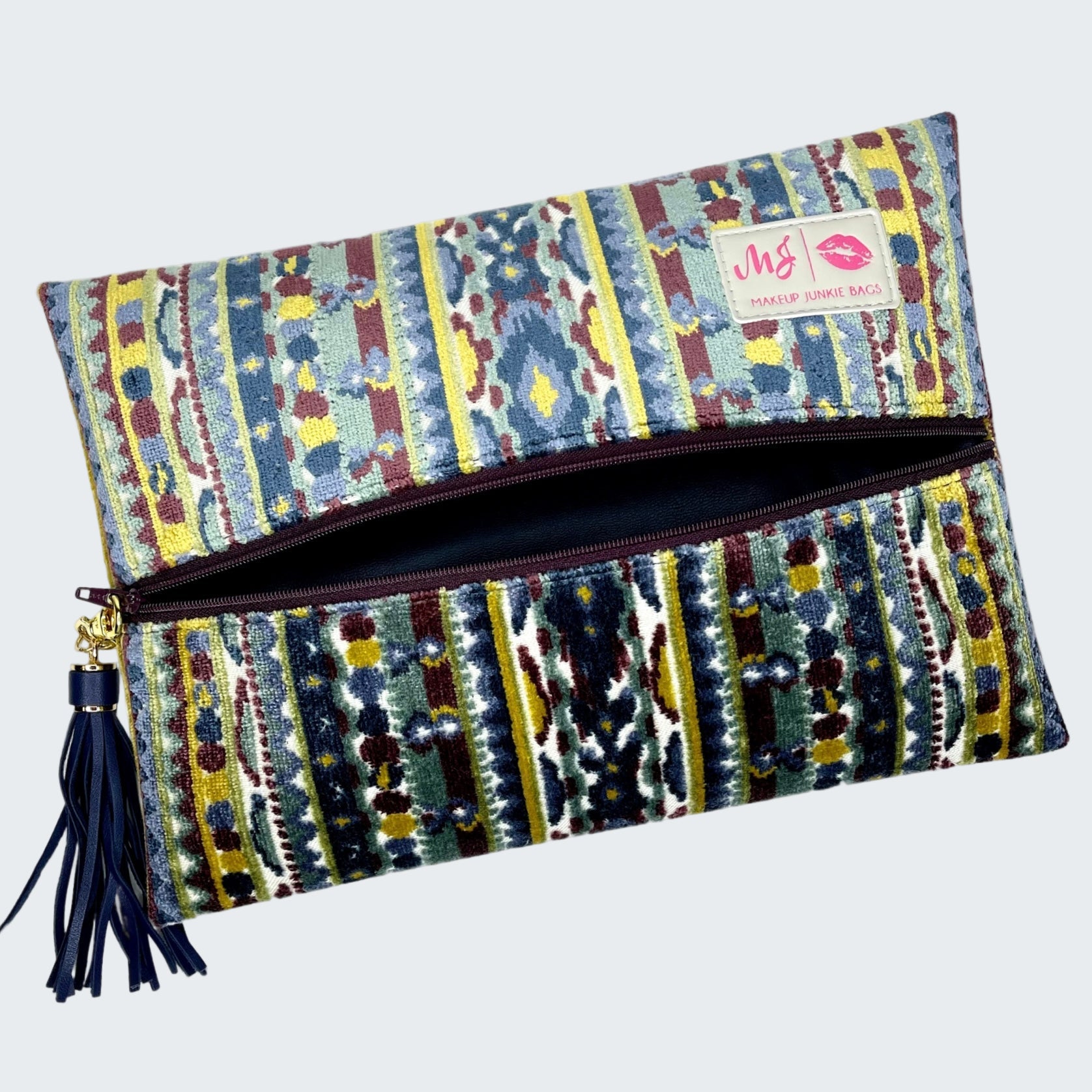 Colorful patterned clutch bag with a visible brand logo on a white background