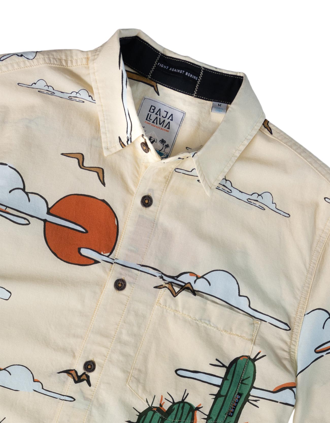Beige shirt with desert-themed illustrations and 'Baja Bava' label.