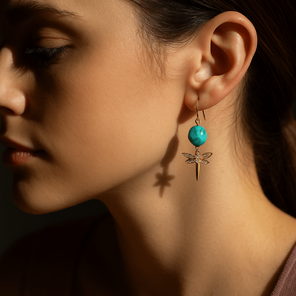 Close-up of a woman wearing a turquoise earring with a dragonfly design.