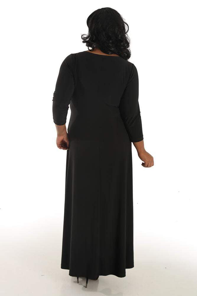 Woman wearing a black dress with long sleeves on a white background