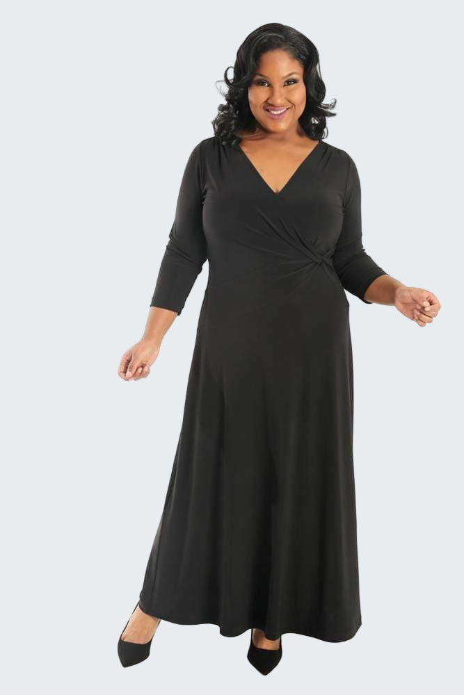 Woman wearing a black long-sleeve dress on a white background