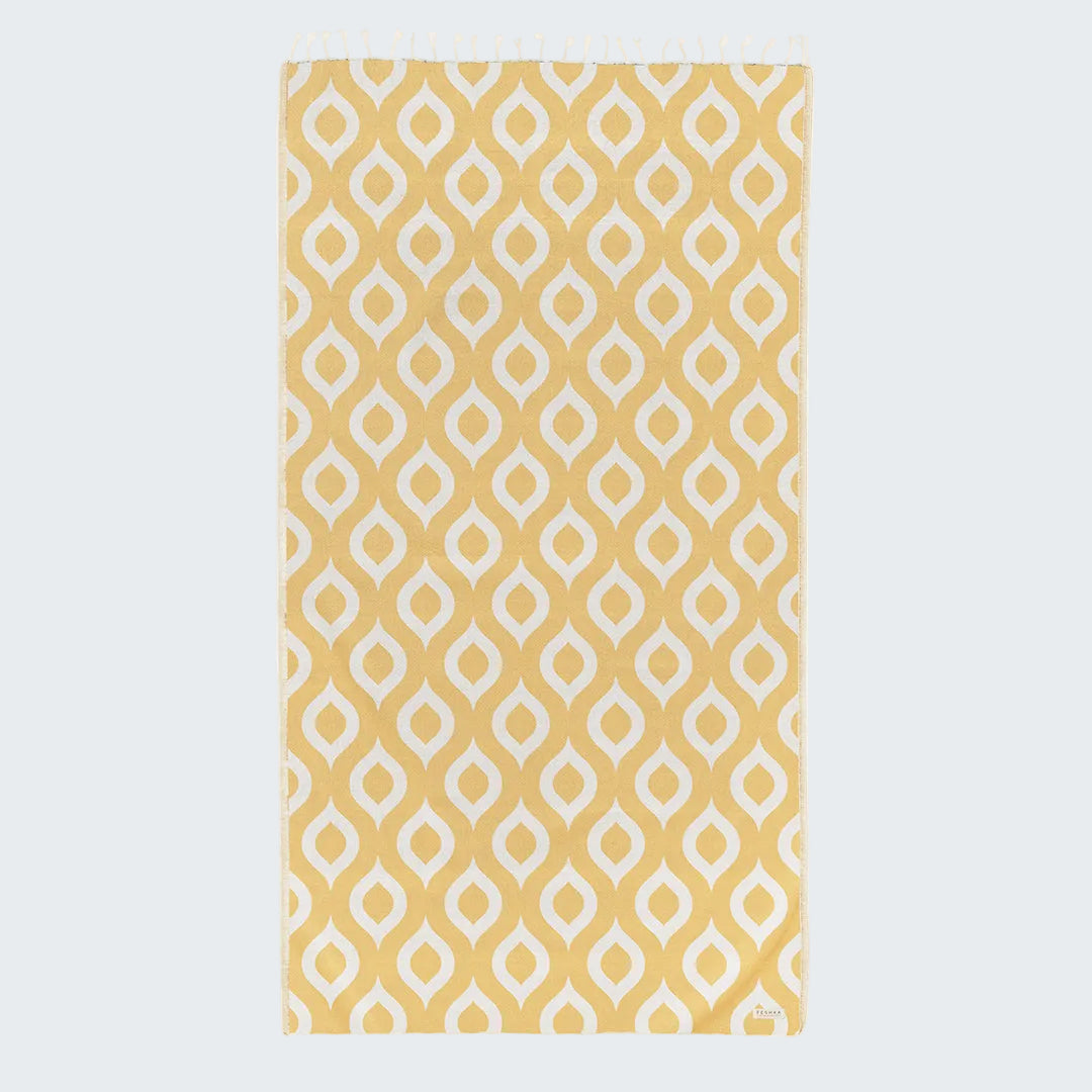 Yellow and white patterned rug on a plain background