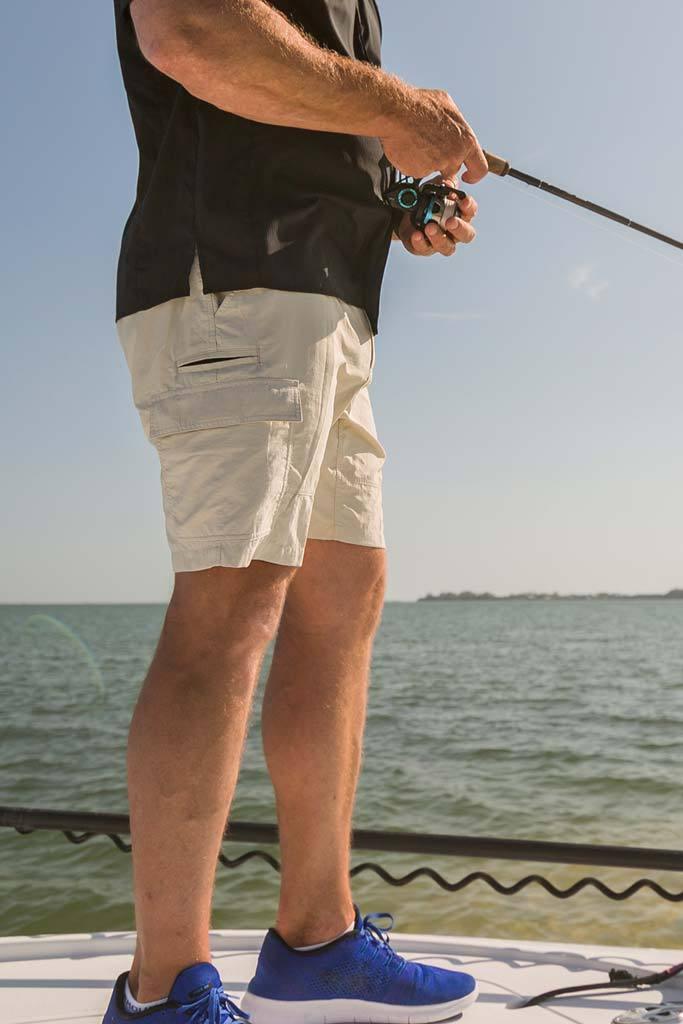 Person fishing on a boat with water and sky in the background