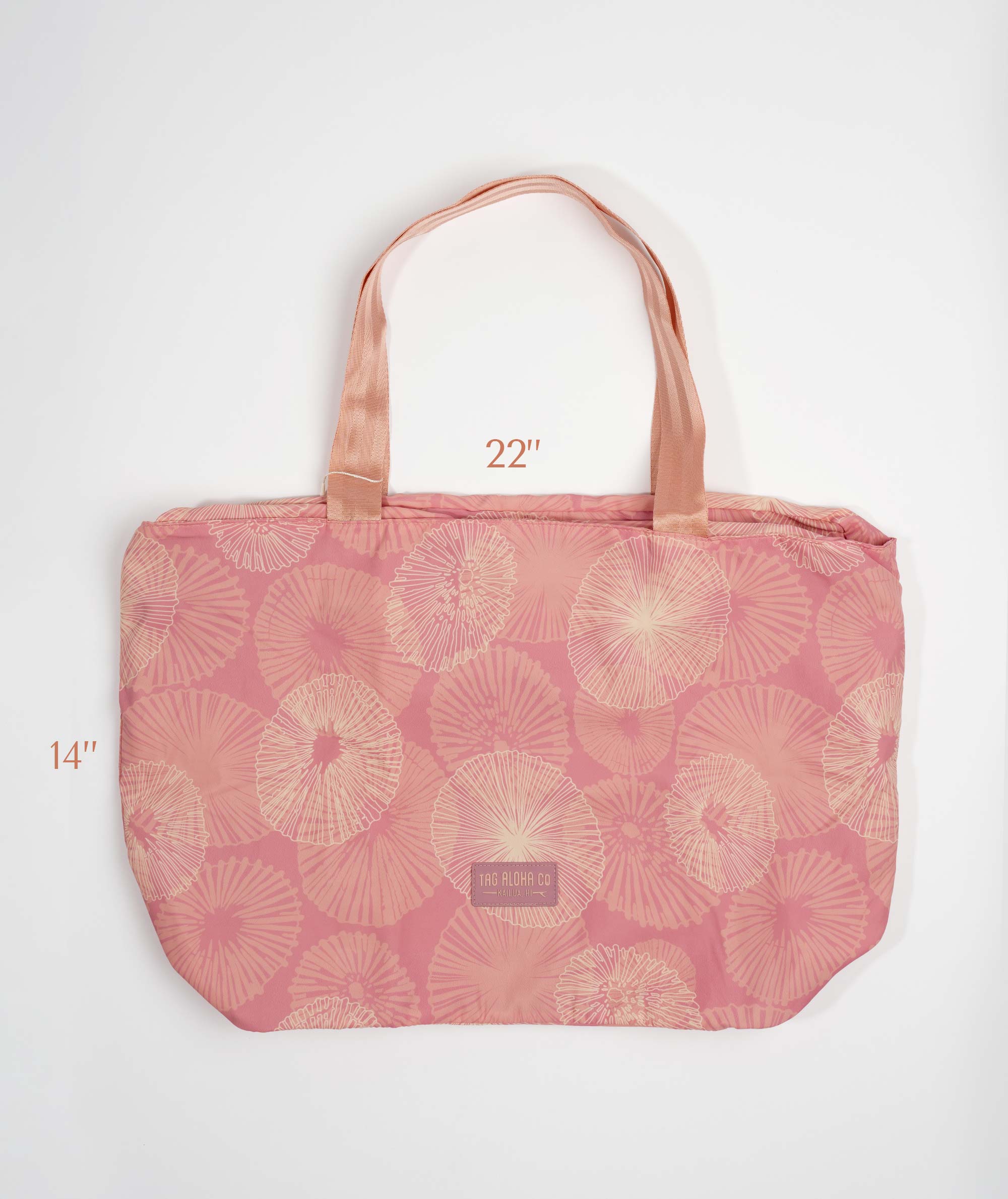 Pink tote bag with floral pattern on a white background