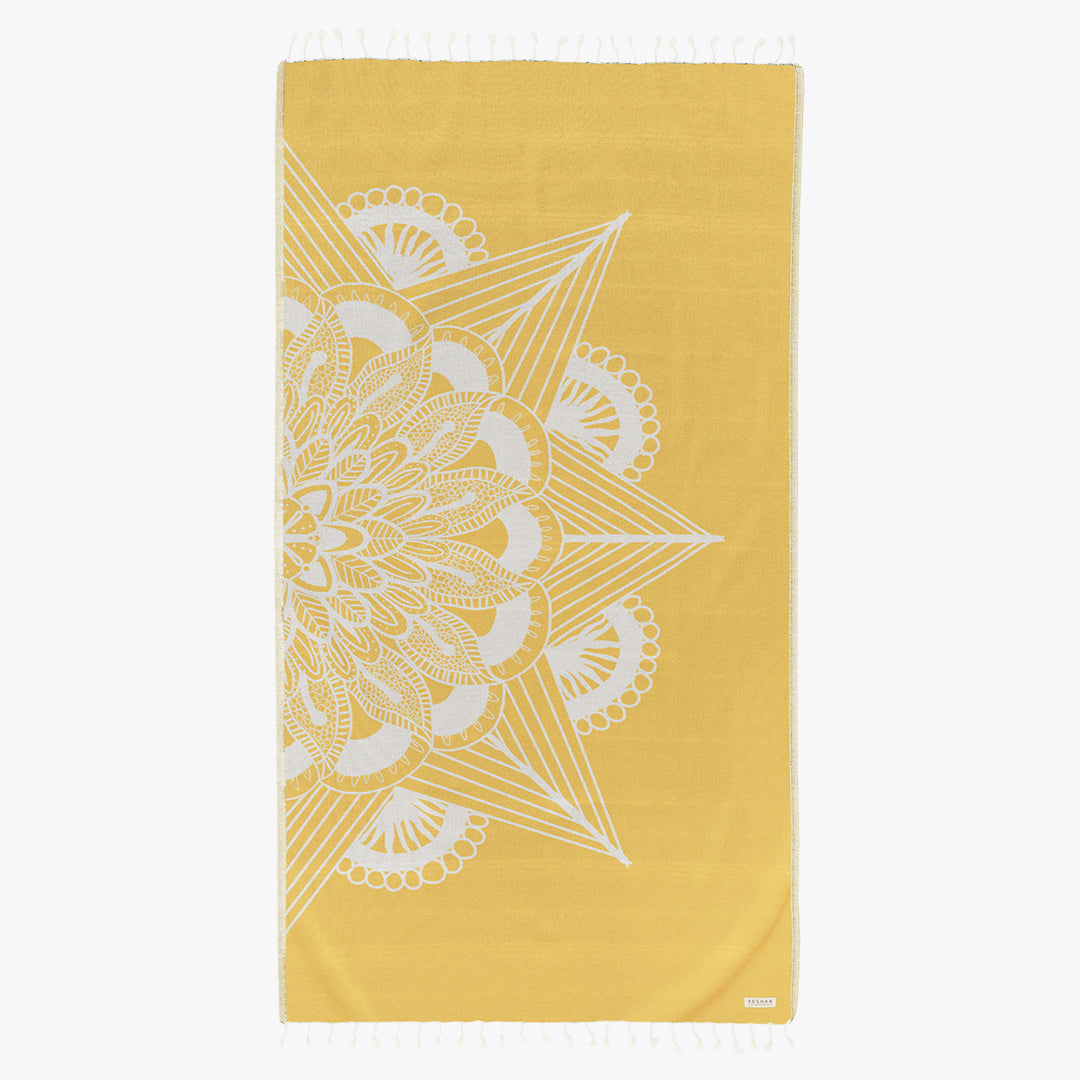 Yellow towel with white geometric pattern on a white background