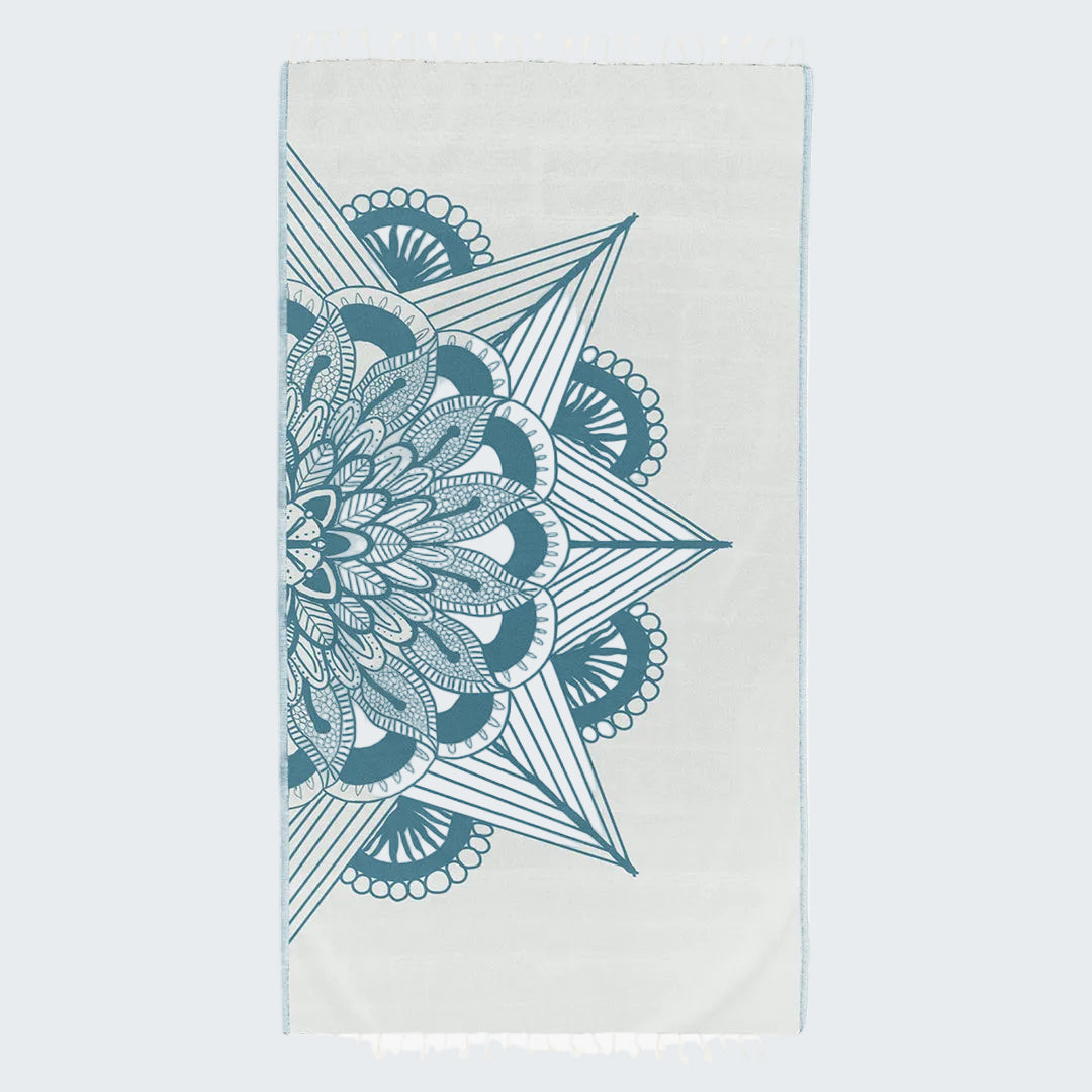 Teal geometric design on a white towel
