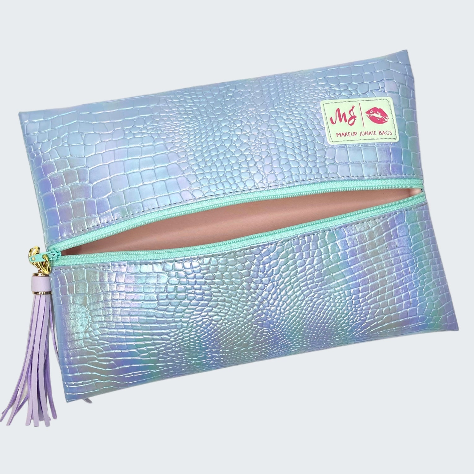 Iridescent makeup bag with a tassel on a white background