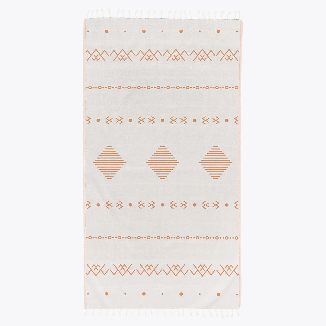 Beige towel with geometric pattern on a white background