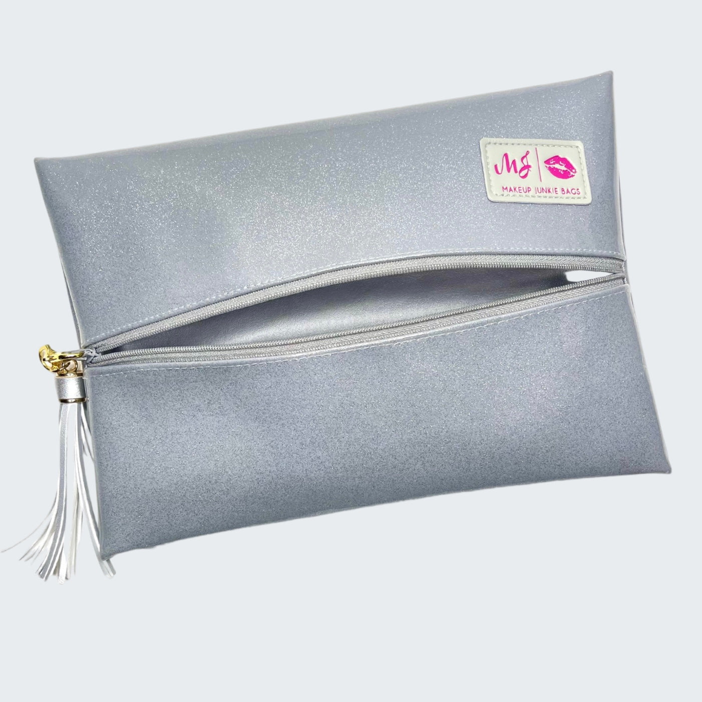Silver makeup bag with a tassel on a white background
