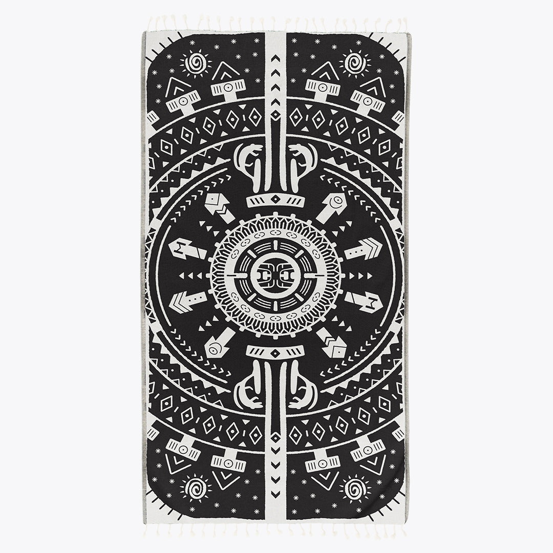 Black and white patterned towel with geometric design on a white background