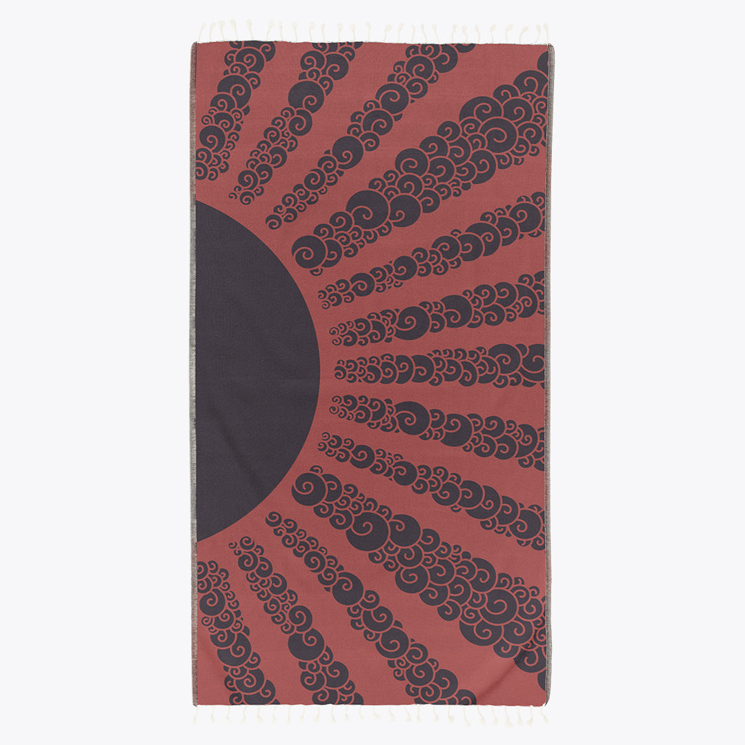 Towel with black swirling pattern on a red background