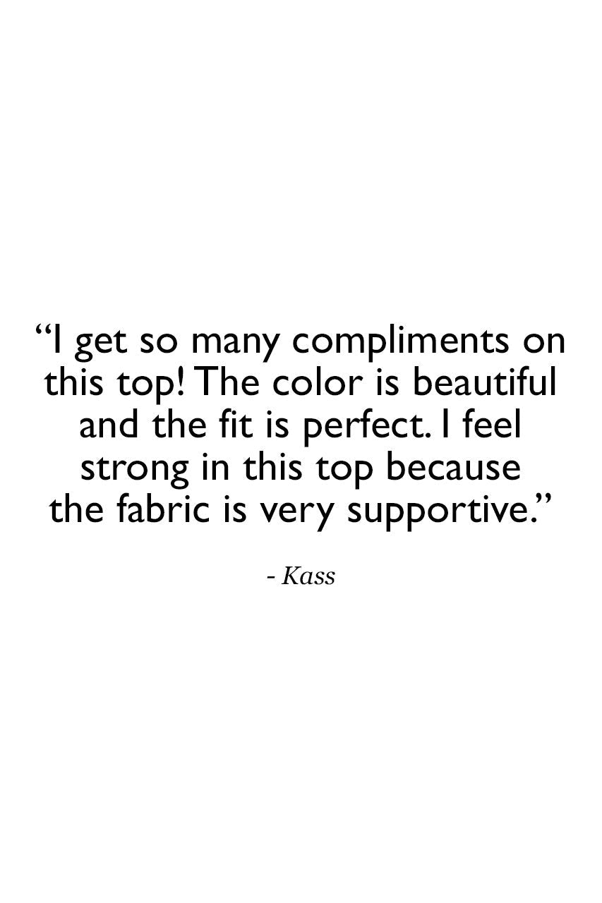 Text on a white background with a quote about compliments on a top, color, fit, and fabric support.