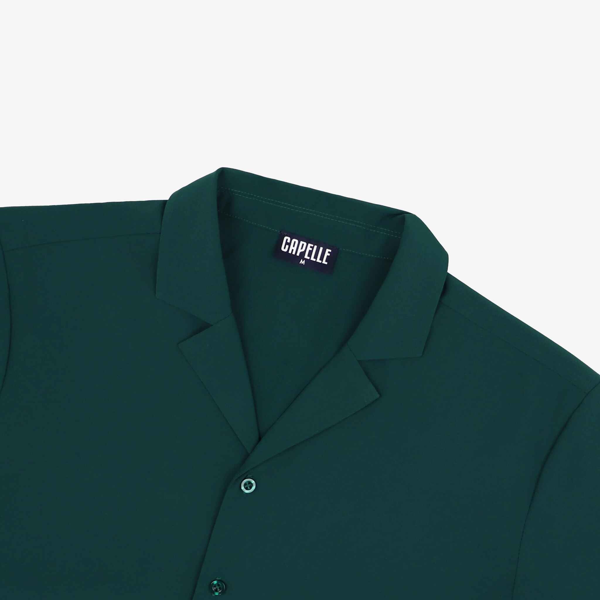 Green shirt with 'Capelle' label on a light gray background