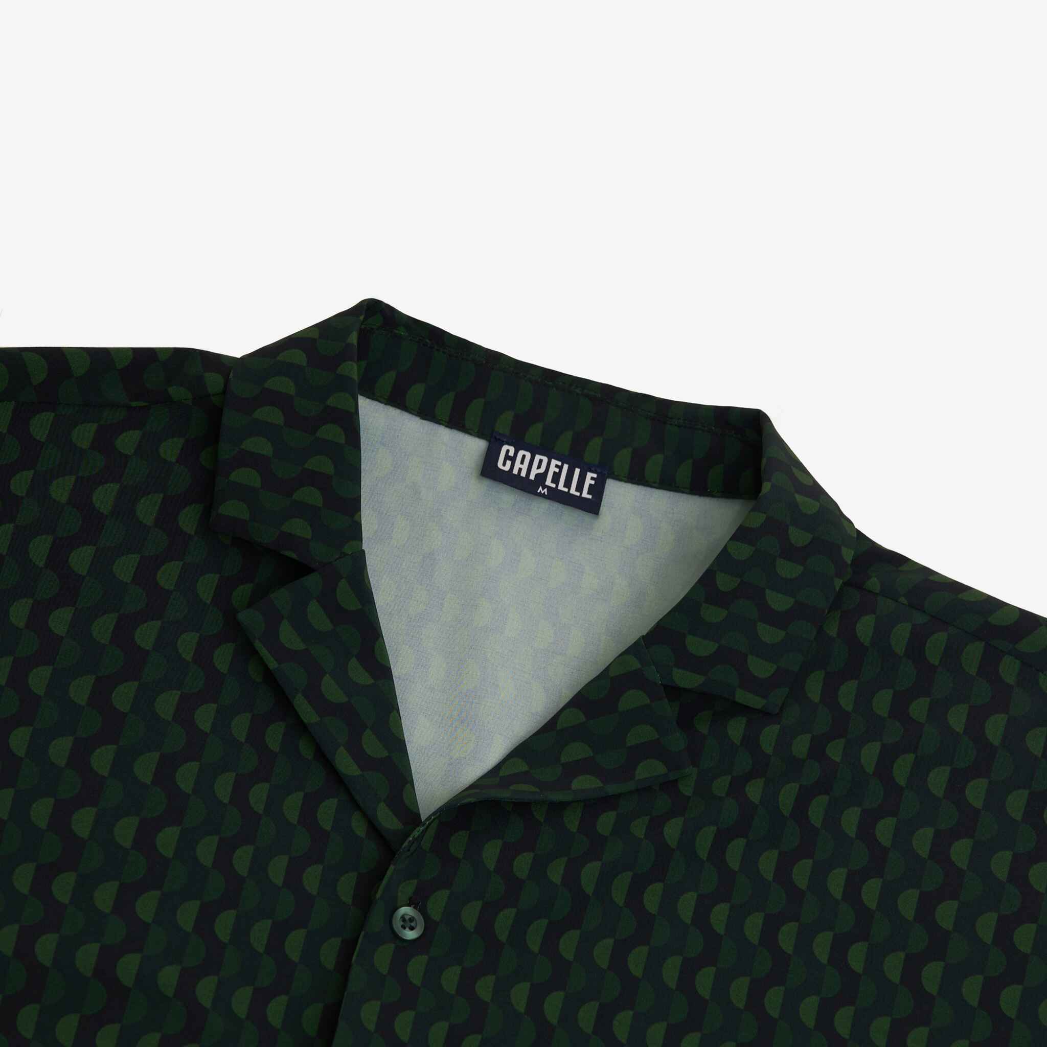 Green patterned shirt with a visible brand label on a white background