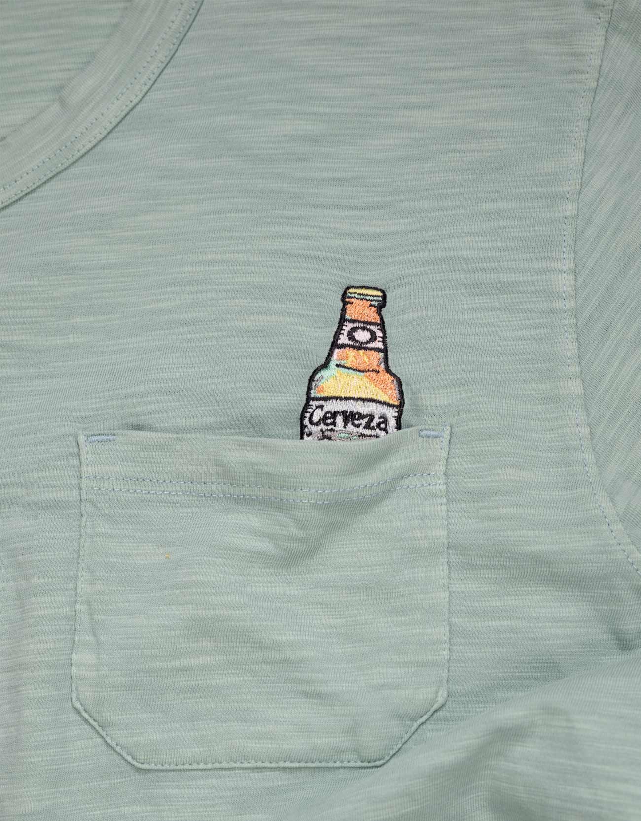 Light blue t-shirt with a bottle graphic on the chest pocket