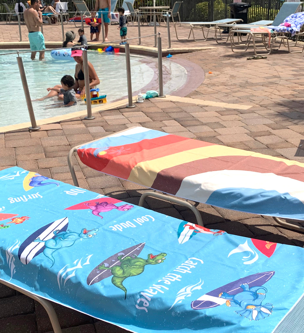 Children playing in a pool with lounge chairs and beach towels nearby.