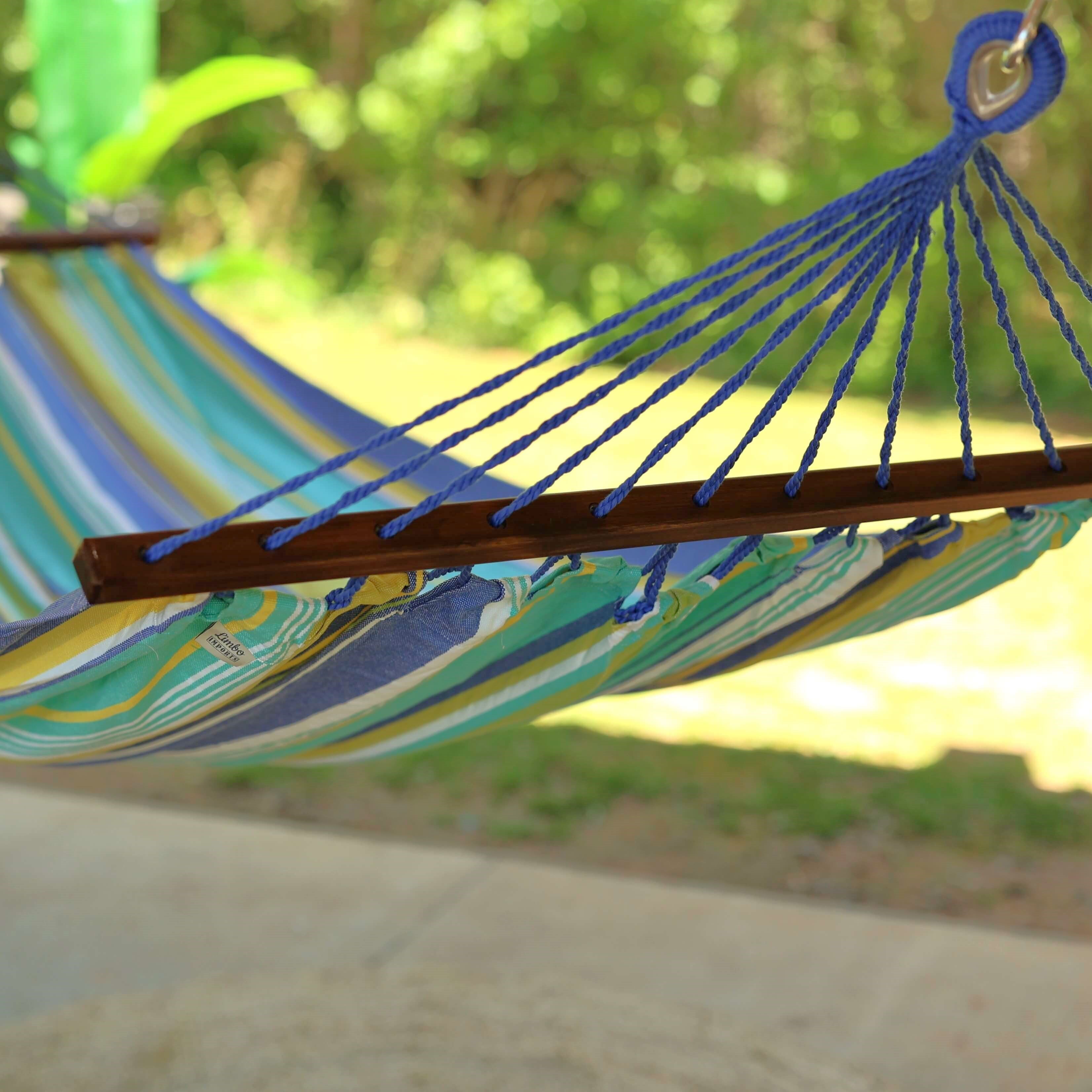Colorful striped hammock hanging outdoors with a blurred natural background