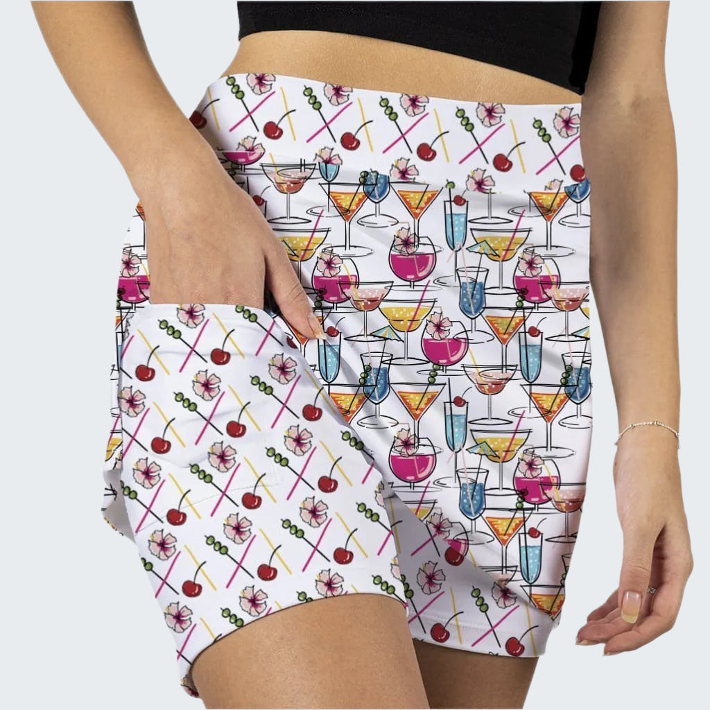 Shorts with a colorful cocktail and cherry pattern on a white background