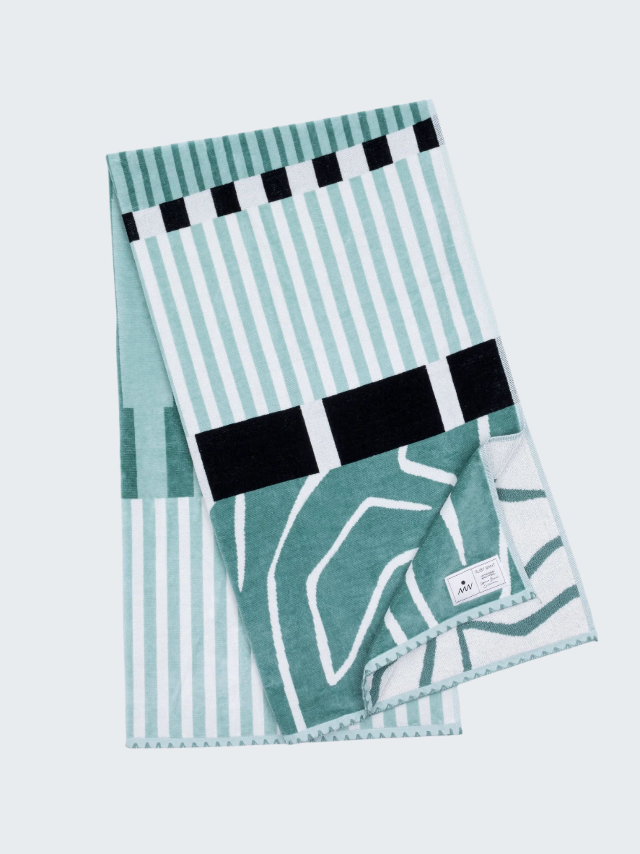 Teal and white patterned towel with black accents on a white background