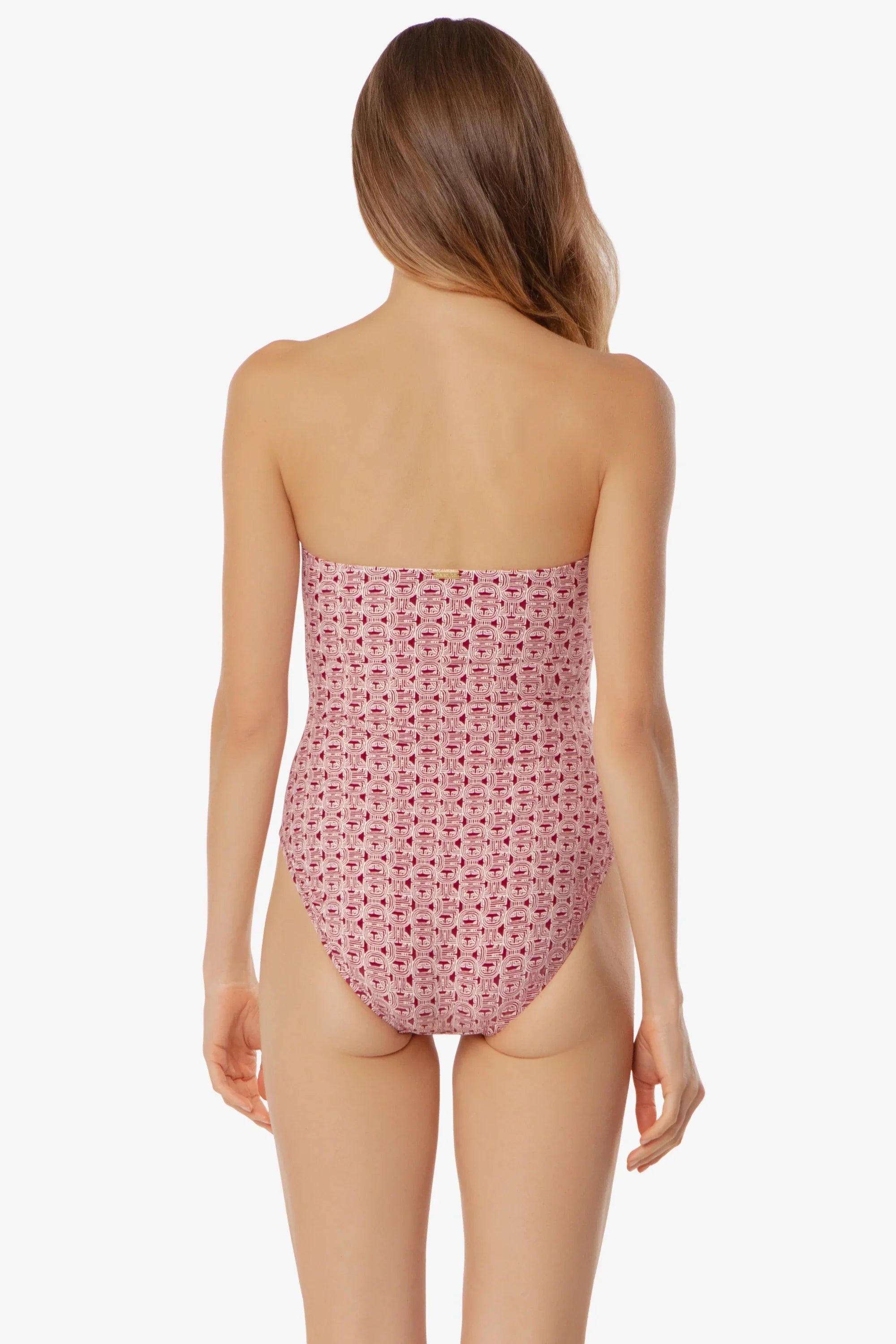 Woman wearing a strapless pink floral swimsuit on a white background