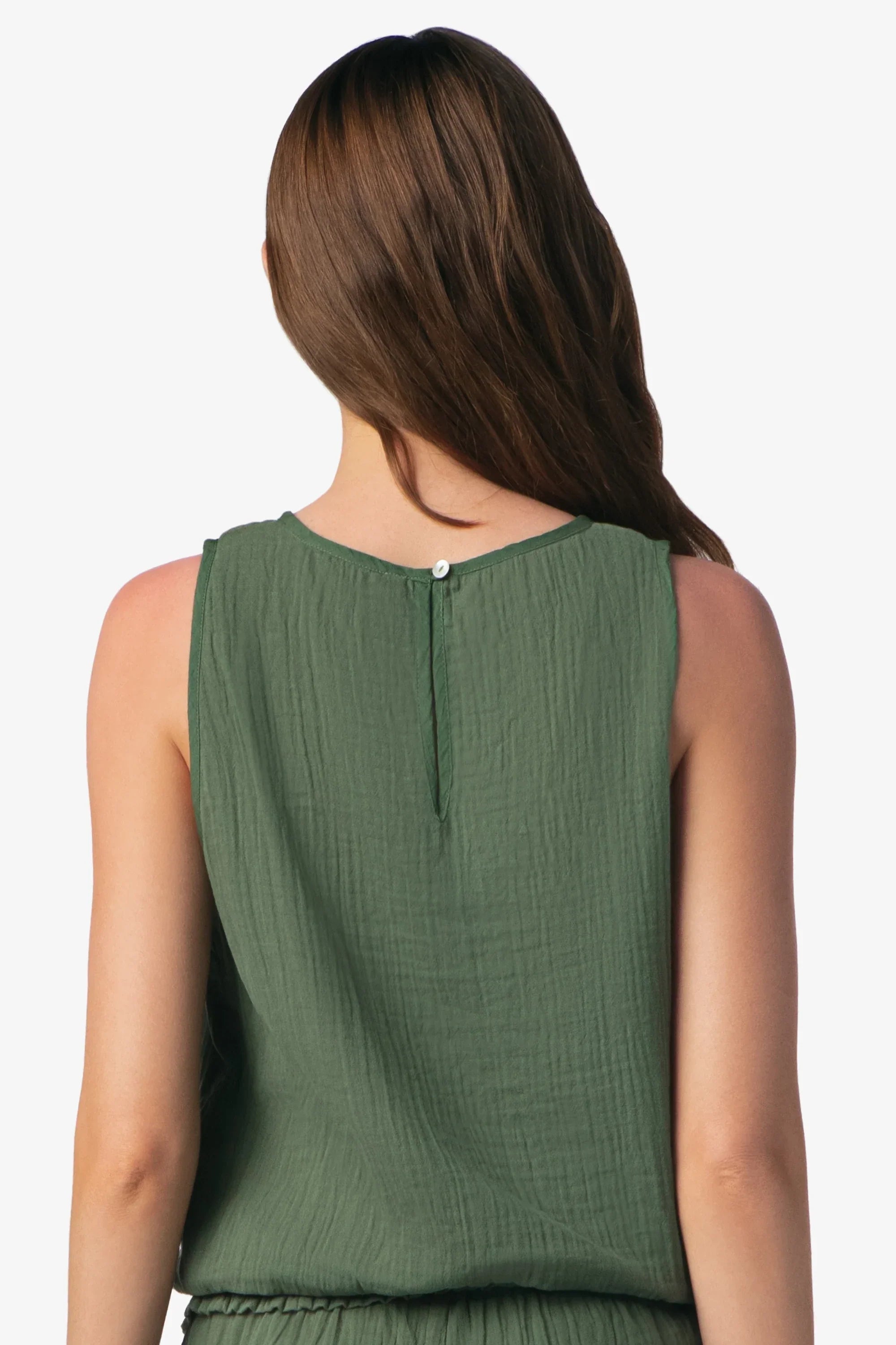 Green sleeveless top worn by a person on a white background