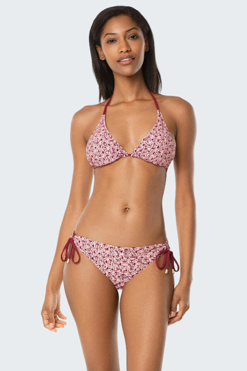 Woman wearing a pink floral bikini set on a white background
