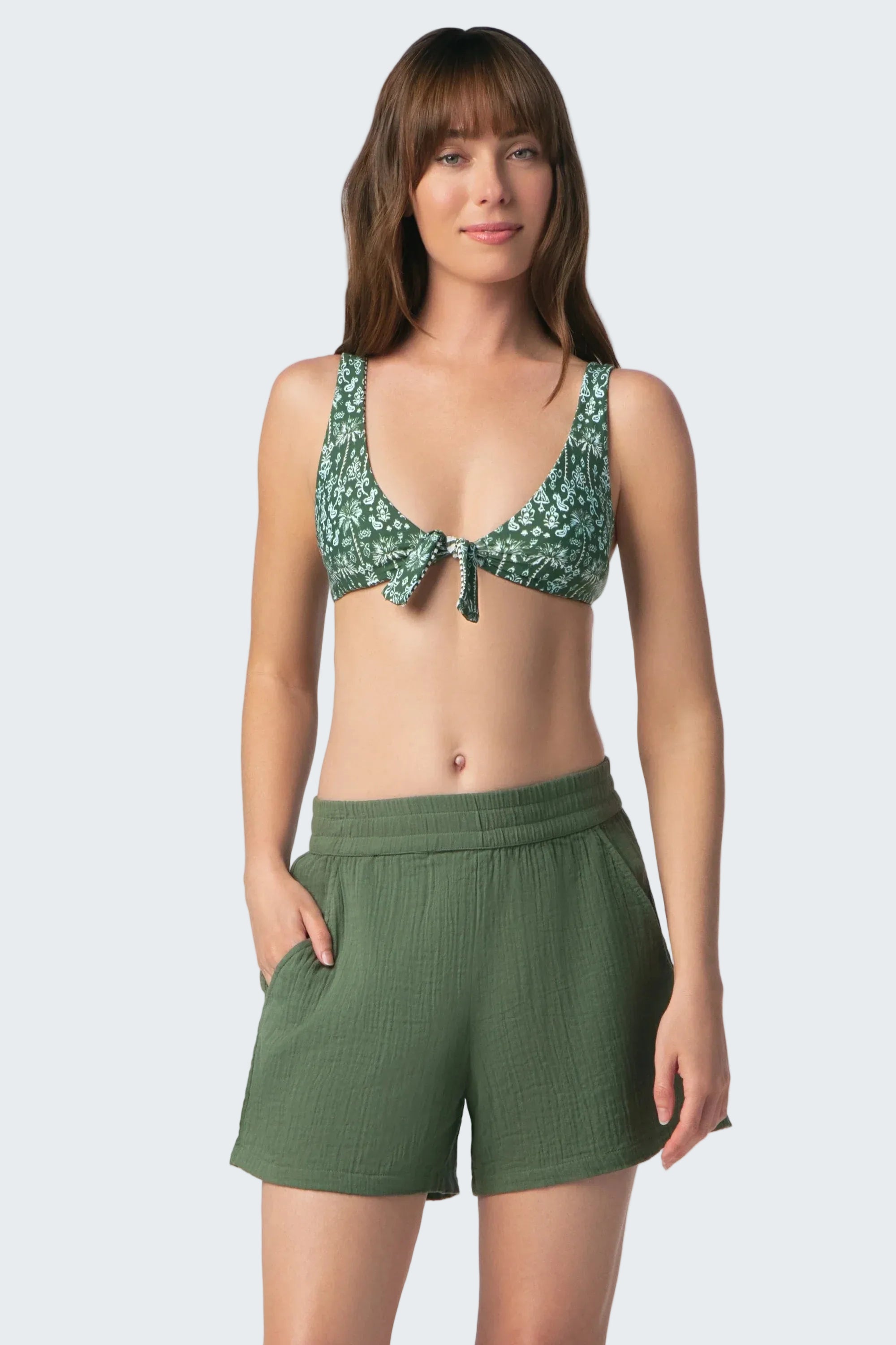 Woman wearing a green bikini set on a white background