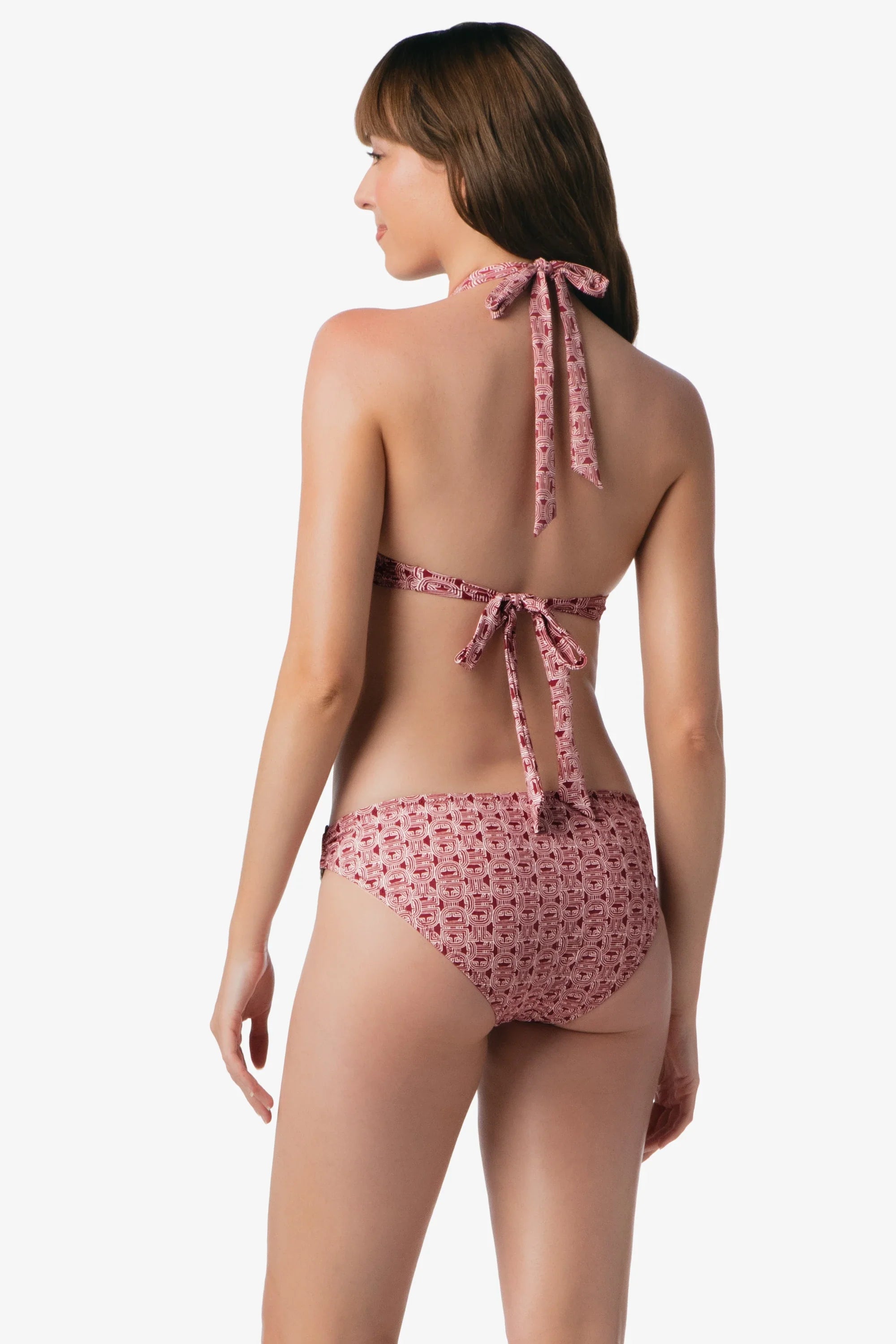 Woman wearing a pink floral bikini with a white background