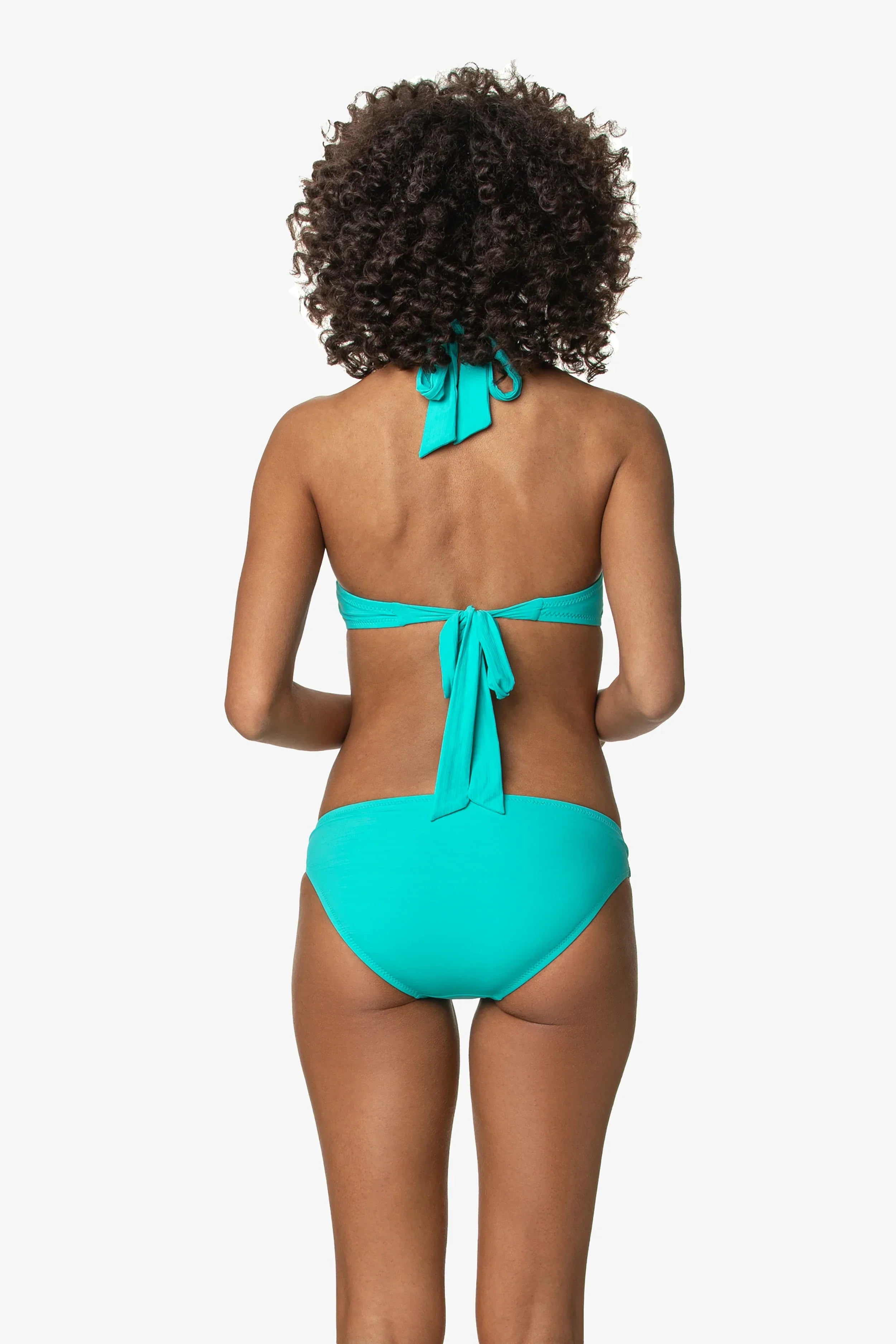 Person wearing a turquoise bikini on a white background
