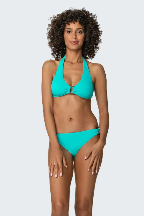 Woman wearing a turquoise bikini against a white background
