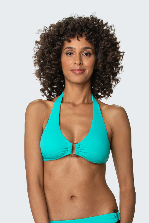 Woman wearing a turquoise bikini top against a white background