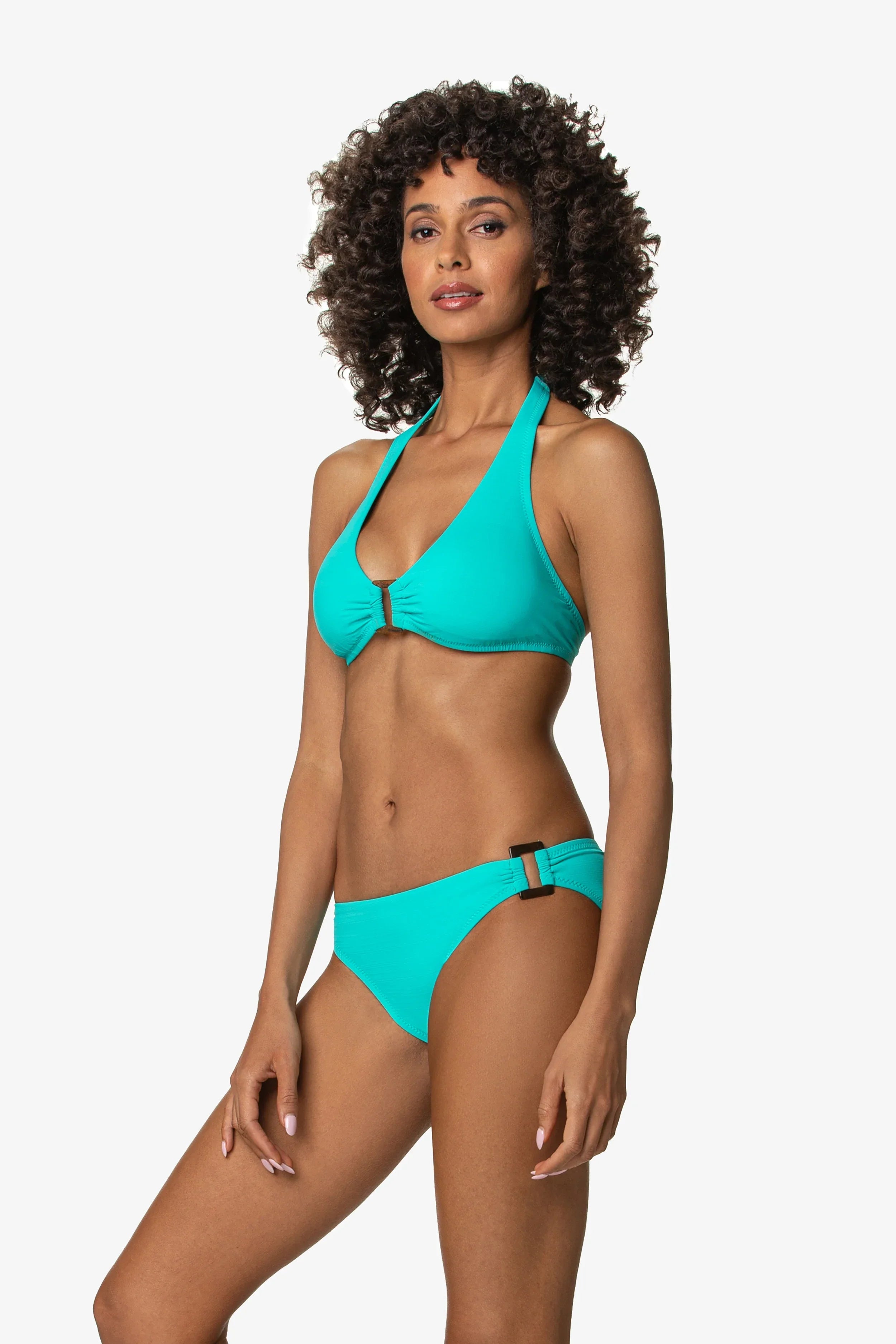 Woman wearing a turquoise bikini against a white background