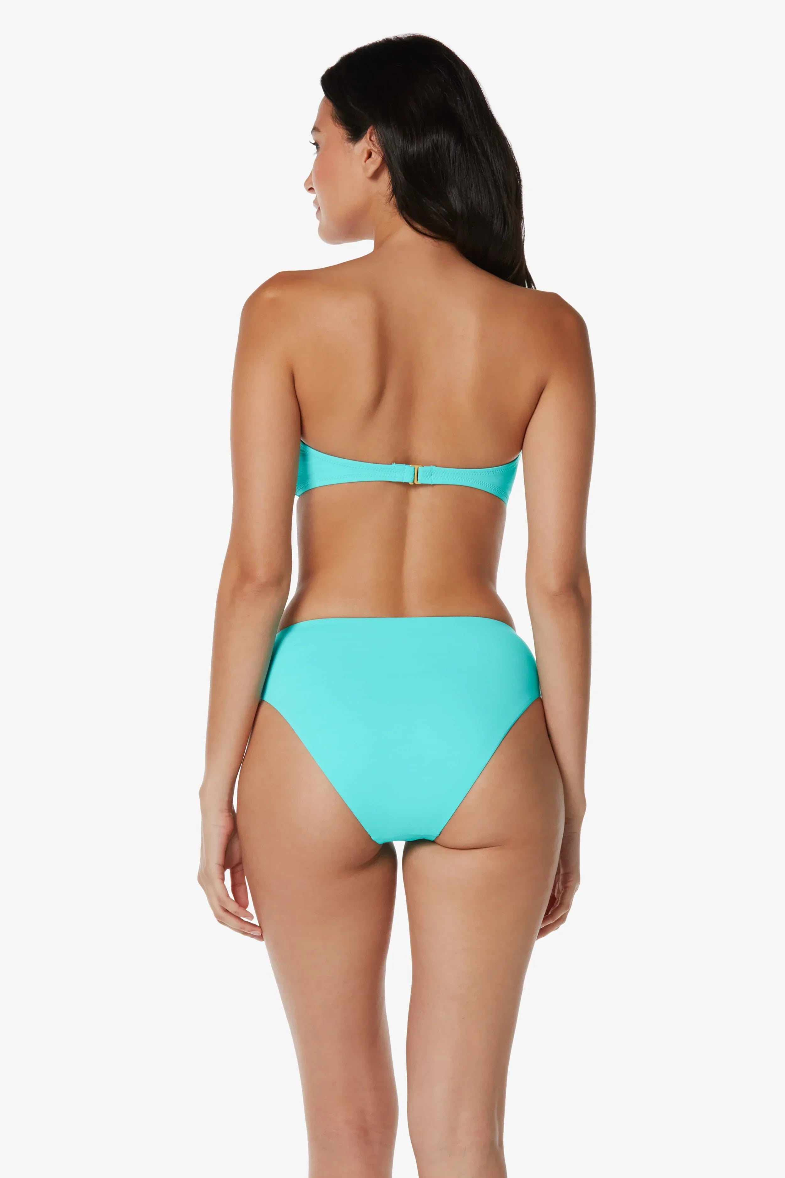 Woman wearing a turquoise bikini set on a white background