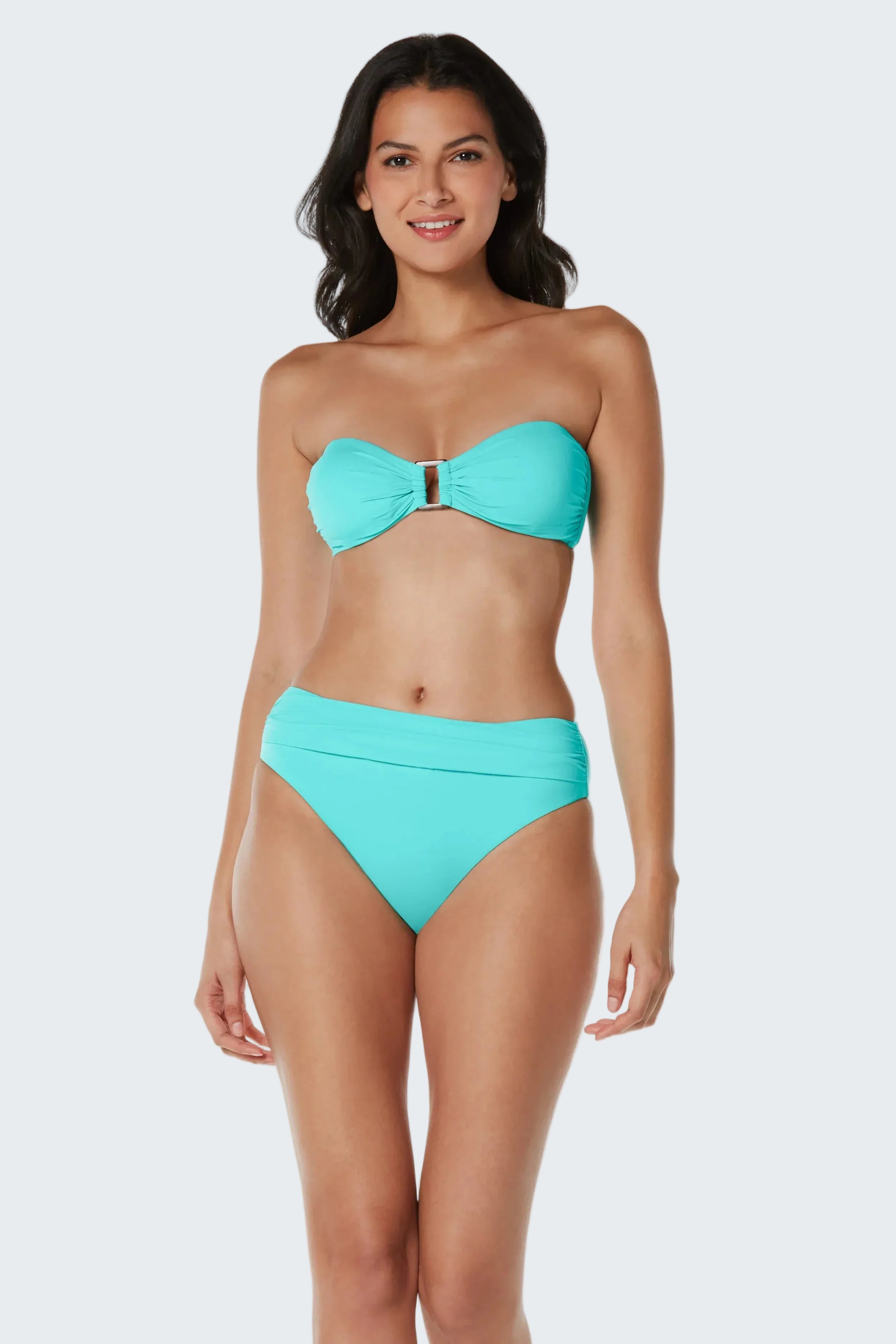 Woman wearing a turquoise bikini on a white background