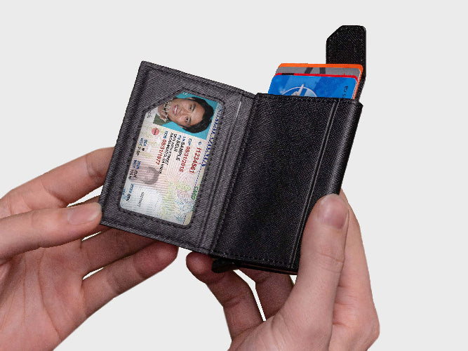 Black wallet with cards and an ID card held by a hand on a white background
