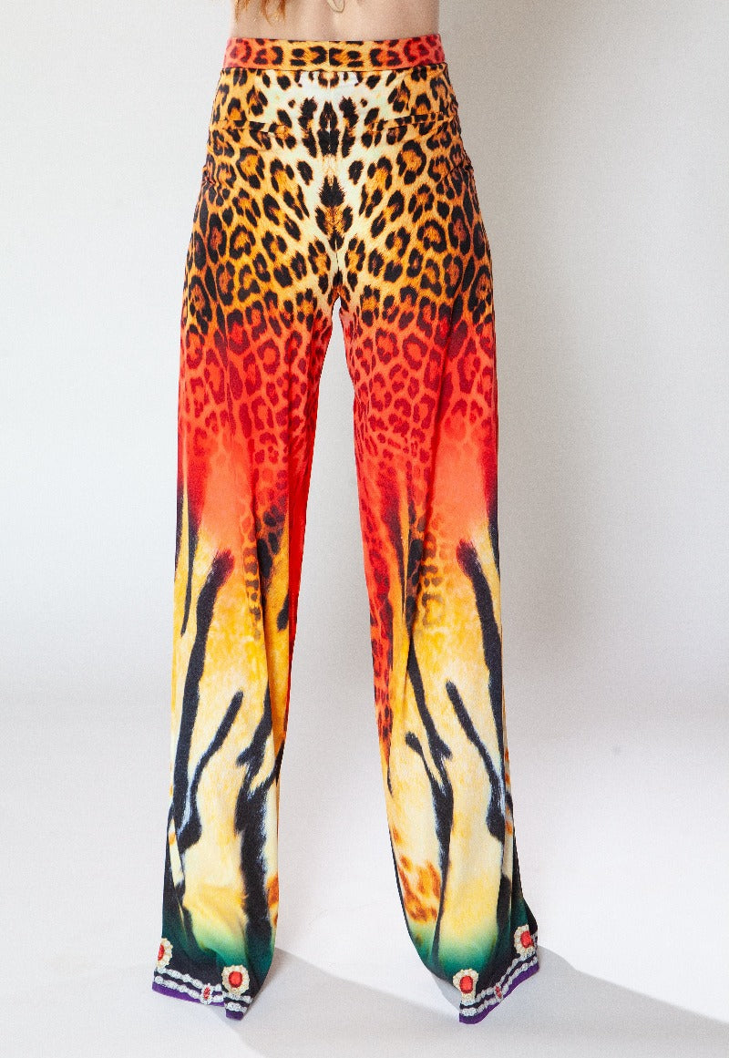Leopard print pants with a gradient of colors on a white background