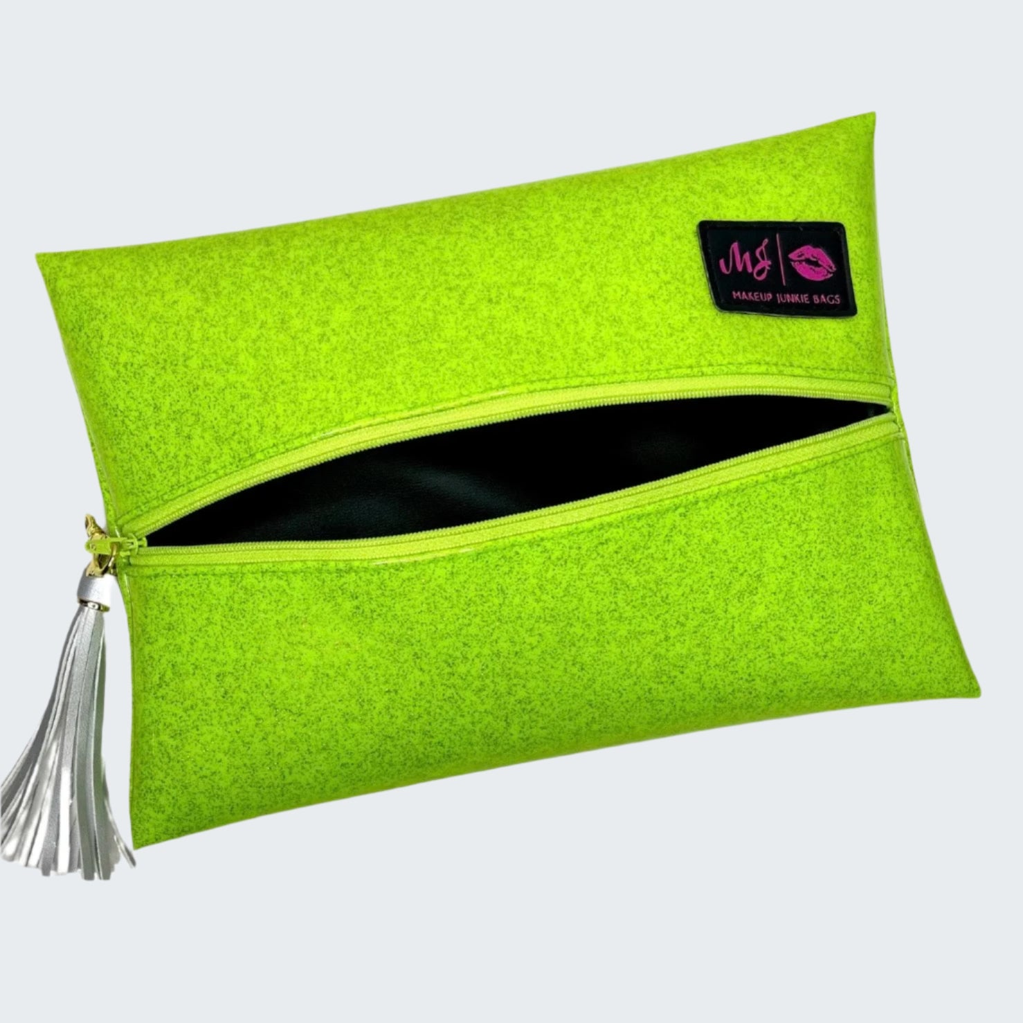 Green clutch bag with a tassel on a white background