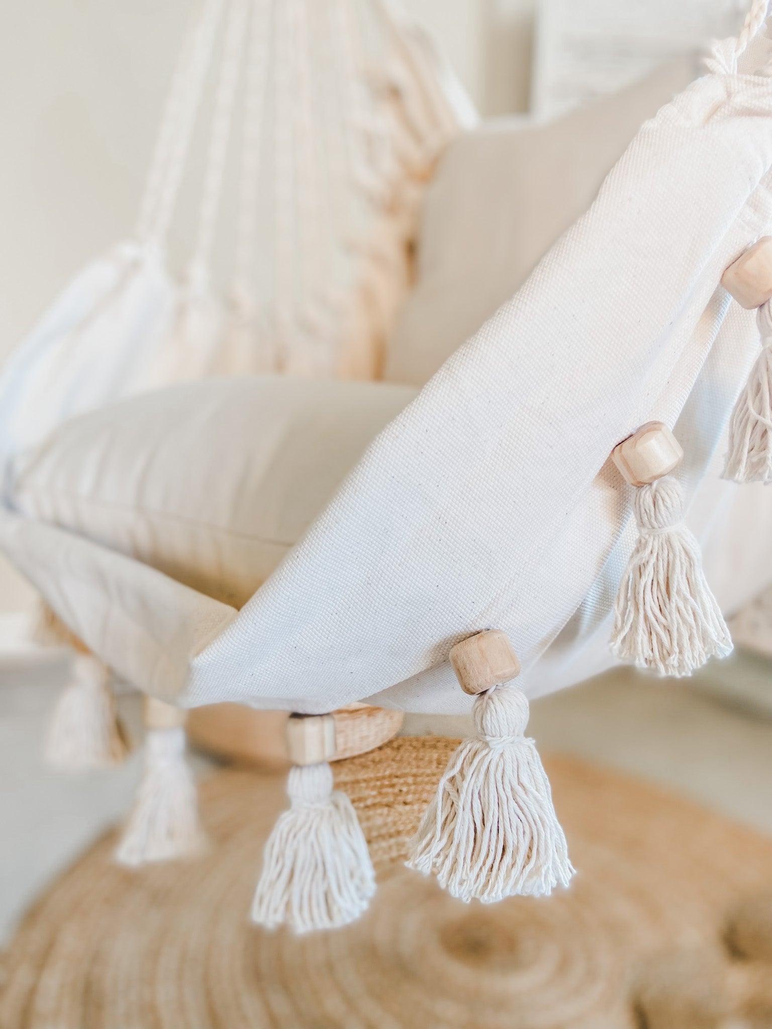 Decorative pillow with tassels on a neutral background