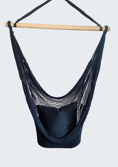 Navy blue hammock chair hanging in a room with decorative elements.
